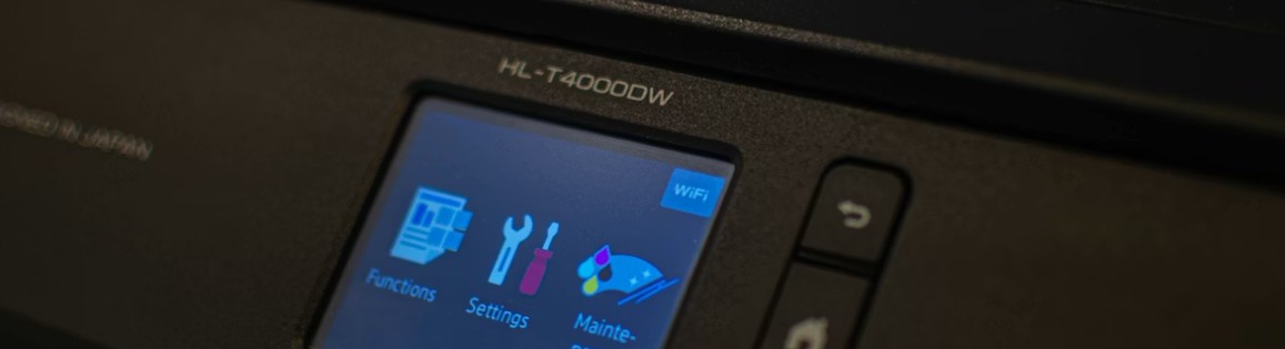 Närbild på en skrivardisplay som visar ikoner för funktioner, inställningar och underhåll.